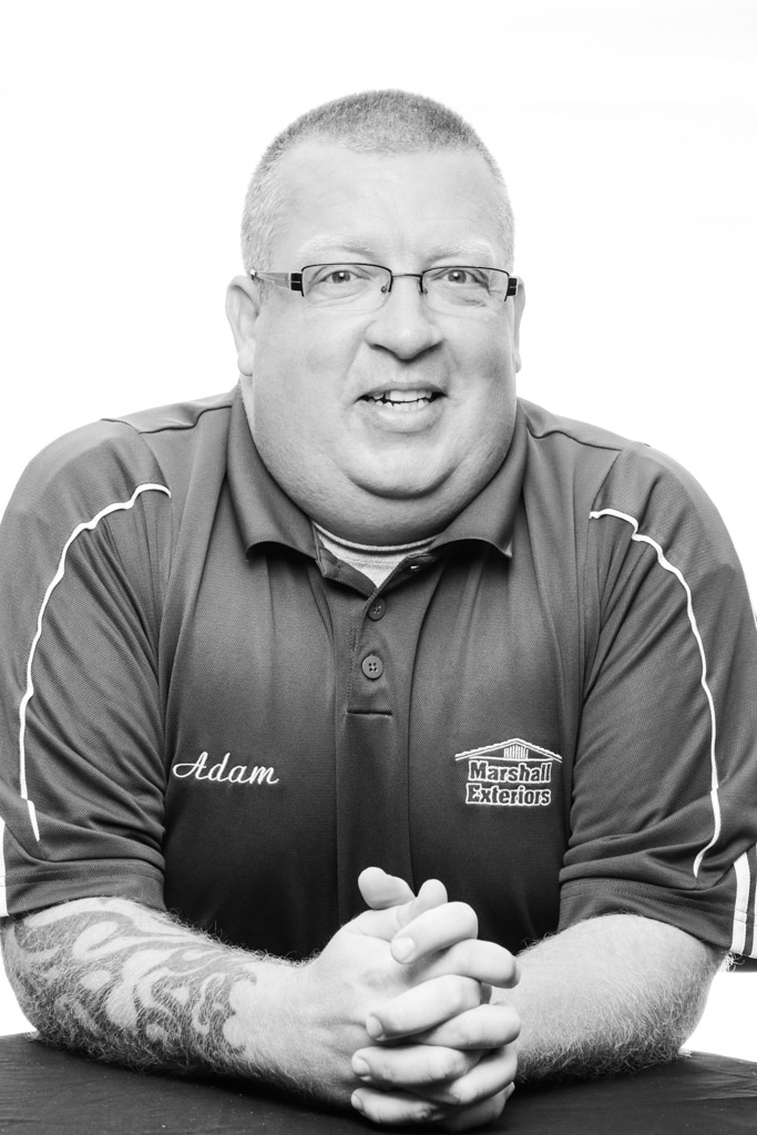 Adam has over 30 years of extensive experience in home improvements and renovations. Adam started as a laborer at eleven, cleaning up roofing debris from the ground. Later in his teens, he helped tear off and eventually learned to install various roof systems. In his twenties, he worked for a custom builder, learning windows, doors, siding, and other various home trades. Adam founded Marshall Exteriors in 2000 at age twenty-six with a hammer and “2 bloody thumbs”. He grew the company from a single-car garage into a company with multiple facilities with over 100 installers on staff. Adam also owns our sister company, Finger Lakes Construction, a large Post Frame building company (pole barns). Adam occasionally still puts on a tool belt to help in a pinch. Adam now primarily spends his working hours doing what he enjoys the most, meeting with homeowners and helping them create a vision for their home and bringing it to completion. 
