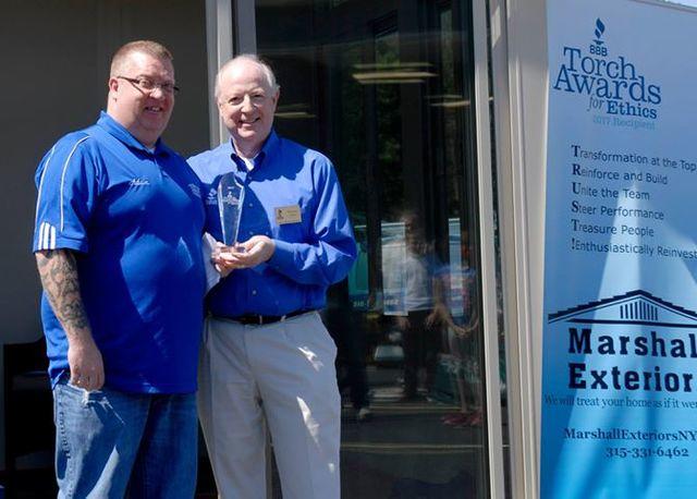 Members of Marshall Exteriors, LLC team with award for ethics