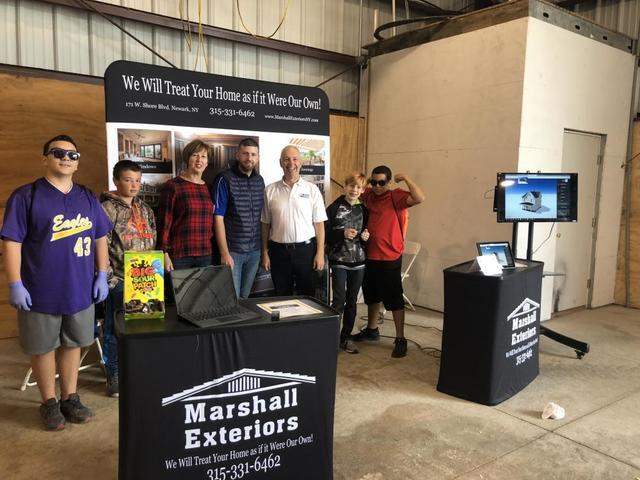 Family at the Marshall Exteriors, LLC booth at the career carnival